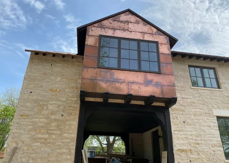 Copper metal panel facade on a stone building for Roof Repair in Brookhaven